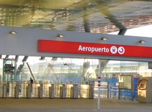 Photo showing the entrance to Malaga airport train station. The airport sign is visiable as is the ticket turnstyles.